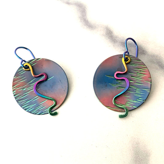 fuchsia, blue, and green textured circle niobium earrings with rainbow anodized squiggle dangles