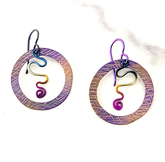 purple and gold circle in a circle earrings with rainbow anodized squiggle dangles in the center