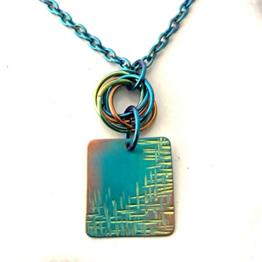 Square niobium necklace textured and anodized lime green, gold, and teal with multicolored mobius
