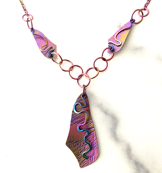 Niobium necklace textured and anodized violet, gold, and fuchsia with multicolored squiggles